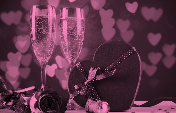 2香槟眼镜和一个心形盒巧克力,粉红色的过滤器